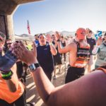 Ambassadors giving high fives to the participants running at the starting line