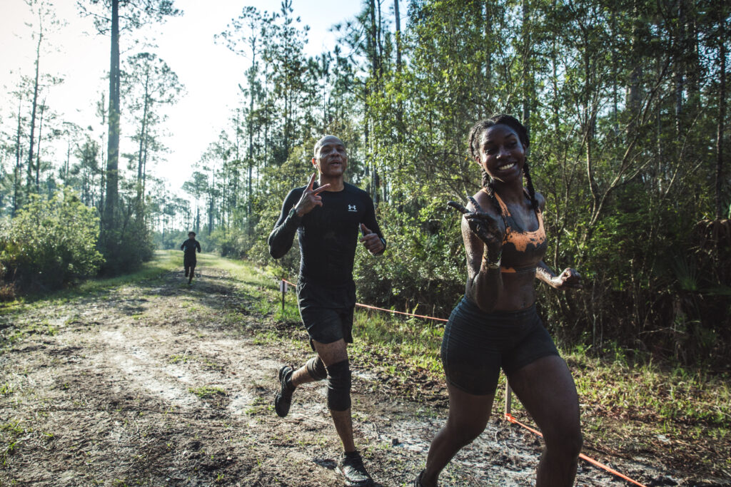 tough mudder people running in wood