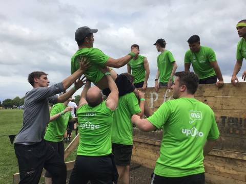 Mark being lifted by his team over Hero Walls