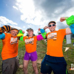 Volunteers flexing muscles with headbands in their arms