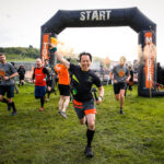 Participant holding a smoke bomb as he ran from the starting line